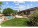 Lush backyard featuring a sparkling pool, mature trees, and meticulously landscaped gardens at 31234 N 47Th Pl, Cave Creek, AZ 85331