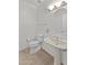 Bright powder room with a pedestal sink, oval mirror, and modern fixtures at 31234 N 47Th Pl, Cave Creek, AZ 85331