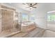 Bathroom featuring tile flooring, a glass door shower, soaking tub, and nature views at 31234 N 47Th Pl, Cave Creek, AZ 85331