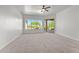 Spacious bedroom featuring plush carpet, a ceiling fan, and a large window to view the desert landscape at 31234 N 47Th Pl, Cave Creek, AZ 85331