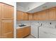 Laundry room with cabinets, a sink, and front loading washer and dryer at 31234 N 47Th Pl, Cave Creek, AZ 85331