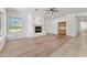 Bright living room with fireplace, ceiling fan, and hardwood flooring at 31234 N 47Th Pl, Cave Creek, AZ 85331