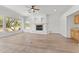 Spacious living room with modern fireplace, ceiling fan, and hardwood flooring at 31234 N 47Th Pl, Cave Creek, AZ 85331