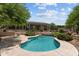 A sparkling pool with meticulously landscaped gardens, mature trees, and desert plantings at 31234 N 47Th Pl, Cave Creek, AZ 85331