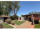 Spacious backyard featuring gravel, artificial turf, brick pavers and beautiful landscaping at 3201 E Colter St, Phoenix, AZ 85018