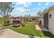 Beautiful backyard with turf, fireplace, patio seating, and brick pavers at 3201 E Colter St, Phoenix, AZ 85018