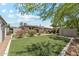A spacious backyard area features turf, privacy walls, brick pavers and an outdoor seating area at 3201 E Colter St, Phoenix, AZ 85018