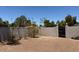 A section of the backyard with a gray block privacy wall and gravel at 3201 E Colter St, Phoenix, AZ 85018