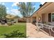 Back patio seating area, turf, beautiful foliage, and brick pavers at 3201 E Colter St, Phoenix, AZ 85018