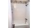 Bright white bathtub with white tiles and decorative trim at 3201 E Colter St, Phoenix, AZ 85018