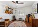 Inviting bedroom with guitars hanging on the wall, ceiling fan, and hardwood floors at 3201 E Colter St, Phoenix, AZ 85018