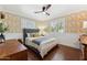 Inviting bedroom with designer wallpaper, ceiling fan, and hardwood floors at 3201 E Colter St, Phoenix, AZ 85018