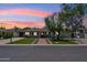 Charming home with manicured front yard, brick walkway, and mature trees against a vibrant sunset sky at 3201 E Colter St, Phoenix, AZ 85018