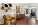 Cozy living room with a comfortable armchair, vintage decor, and hardwood floors at 3201 E Colter St, Phoenix, AZ 85018
