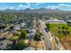Aerial view of single-Gathering homes and tree-lined streets with a park and mountain views at 3649 E Delcoa Dr, Phoenix, AZ 85032