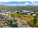View of a well-maintained neighborhood with an open green space and a baseball field with a school nearby at 3649 E Delcoa Dr, Phoenix, AZ 85032