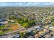 Aerial view capturing a residential neighborhood near a baseball field and open green space with the mountains in the distance at 3649 E Delcoa Dr, Phoenix, AZ 85032