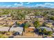 Expansive view of a residential neighborhood with tree-lined streets, various architectural styles, and distant mountains at 3649 E Delcoa Dr, Phoenix, AZ 85032