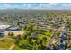 Aerial view of a community with a large park, mature trees, and single Gathering homes at 3649 E Delcoa Dr, Phoenix, AZ 85032