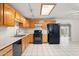 Eat-in kitchen with wood cabinetry, modern appliances, and a skylight for natural light at 3649 E Delcoa Dr, Phoenix, AZ 85032