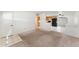 Open living area with tile flooring, carpeted living room, and views into the kitchen, perfect for entertaining at 3649 E Delcoa Dr, Phoenix, AZ 85032