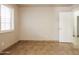 Bright bedroom with tile flooring, large window with blinds, and neutral paint at 3750 S Conestoga Rd, Apache Junction, AZ 85119