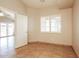 Neutral bedroom featuring tiled flooring, plantation shutters, and an open doorway at 3750 S Conestoga Rd, Apache Junction, AZ 85119