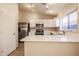 Kitchen featuring white cabinets, stainless steel appliances, and tile flooring at 3750 S Conestoga Rd, Apache Junction, AZ 85119