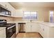 Kitchen featuring white cabinets, stainless steel appliances, and tile flooring at 3750 S Conestoga Rd, Apache Junction, AZ 85119