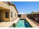 Backyard pool with a blue pool cleaner set alongside the exterior of the home at 3750 S Conestoga Rd, Apache Junction, AZ 85119