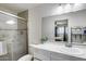 Updated bathroom with a glass shower, white vanity, and modern fixtures at 3807 N 56Th Dr, Phoenix, AZ 85031