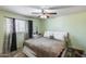 Bright bedroom with ample natural light, a ceiling fan, and neutral decor at 3807 N 56Th Dr, Phoenix, AZ 85031