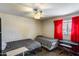 Well-lit bedroom with painted brick wall, ceiling fan, and comfortable sleeping arrangements at 3807 N 56Th Dr, Phoenix, AZ 85031