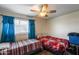 Bedroom with two beds, wood flooring, and a window with blinds at 3807 N 56Th Dr, Phoenix, AZ 85031