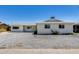 Charming single-story home with gravel front yard and a well-lit porch, perfect for relaxing outdoors at 3807 N 56Th Dr, Phoenix, AZ 85031