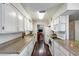 Galley kitchen featuring white cabinets and stone countertops at 3807 N 56Th Dr, Phoenix, AZ 85031