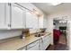 Kitchen featuring stone countertops, a double sink, and white appliances at 3807 N 56Th Dr, Phoenix, AZ 85031