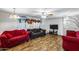 Cozy living room with hardwood floors, a decorative fireplace and ample seating at 3807 N 56Th Dr, Phoenix, AZ 85031