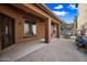 Extended covered patio features brick pavers, shade, and an area for outdoor dining at 3850 E Geronimo St, Gilbert, AZ 85295