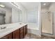 Bathroom features double sinks, tiled floors, separate shower, and a glass block window over the tub at 3850 E Geronimo St, Gilbert, AZ 85295