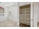 Bedroom with a walk-in closet, tiled floors, and a window with blinds at 3850 E Geronimo St, Gilbert, AZ 85295