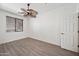 Bedroom with wooden floors, ceiling fan, and a window providing natural light at 3850 E Geronimo St, Gilbert, AZ 85295