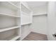 Walk-in closet with built-in shelving and wood-look floors is ready for organizing clothes at 3850 E Geronimo St, Gilbert, AZ 85295