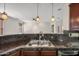 Kitchen with double sink, stainless steel faucet, and open view to the living area at 3850 E Geronimo St, Gilbert, AZ 85295