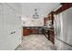 Bright kitchen with tiled floors, stainless steel refrigerator, and stylish lighting fixtures at 3850 E Geronimo St, Gilbert, AZ 85295