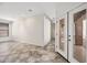Living room with tiled floors, recessed lighting, and double doors to outdoor patio at 3850 E Geronimo St, Gilbert, AZ 85295