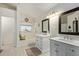 An updated bathroom offers dual sinks, white cabinets, and a separate tub at 4331 E Redwood Ln, Phoenix, AZ 85048