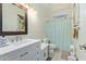 Well-lit bathroom featuring a vanity with drawers and shower with curtain at 4331 E Redwood Ln, Phoenix, AZ 85048