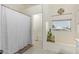 A full bathroom features a shower curtain and a separate tub with modern patterned floors at 4331 E Redwood Ln, Phoenix, AZ 85048