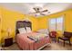 Cozy bedroom featuring a canopy bed, ceiling fan, and natural light at 4331 E Redwood Ln, Phoenix, AZ 85048